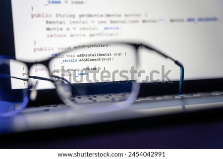 Exploring Programming: Code View, Lens, Glasses, Laptop. keyboard