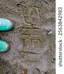 Exploring the sandy river banks of Lake Waccamaw in colorful mud boots.  Fun time digging clam shells