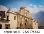 Exploring the stunning architecture of La Merced Church in Antigua, Guatemala under a dramatic sky in the afternoon light