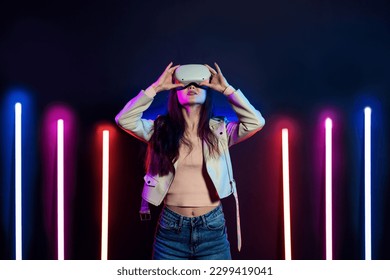 Exploring virtual reality. Woman in vr headset goggles considers 3d space. - Shutterstock ID 2299419041