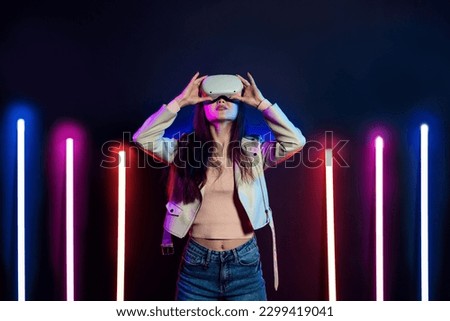 Exploring virtual reality. Woman in vr headset goggles considers 3d space.