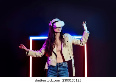 Exploring virtual reality world. Woman in vr headset goggles considers 3d space. - Shutterstock ID 2300135125