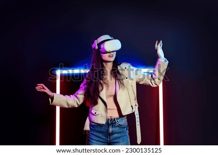 Exploring virtual reality world. Woman in vr headset goggles considers 3d space.