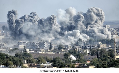 An explosion after an apparent US-led coalition airstrike on Kobane, Syria, as seen from the Turkish side of the border, near Suruc district, 24 October 2014, Sanliurfa, Turkey
