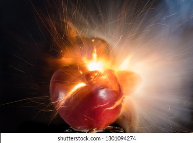 The Explosion Of An Apple And Lemon On A Black Background, Breaking Up, Exploding