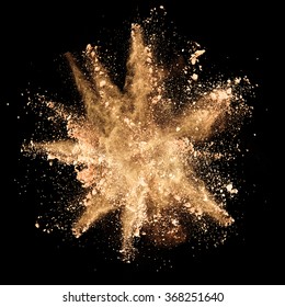 Explosion Of Brown Powder On Black Background