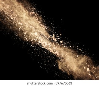 Explosion Of Brown Powder On Black Background