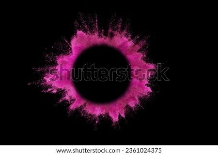 Explosion of colored pink powder with empty space circle for text, isolated on black background