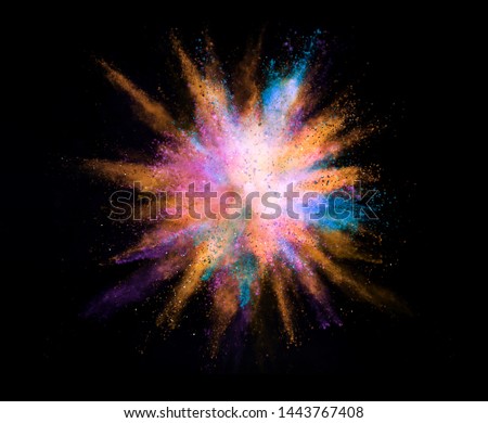 Explosion of colored powder isolated on black background. Abstract colored background