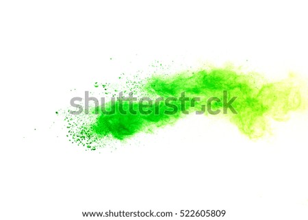 Explosion of colored powder, isolated on white background, green dust