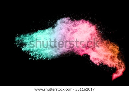 Explosion of colored powder on black background ,Freeze motion of color powder exploding/throwing color powder, multicolored glitter texture.