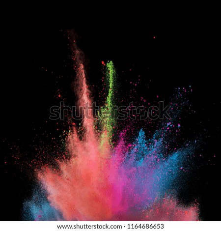 Explosion of coloured powder isolated on black background. Abstract colored background