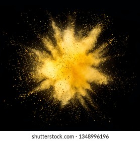 Explosion of golden powder isolated on black background. Abstract colored background