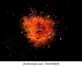 Explosion of red cayenne pepper with flakes and seeds on black background - Shutterstock ID 1934703830
