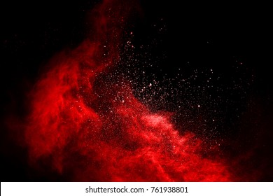 Explosion of red powder on black background.