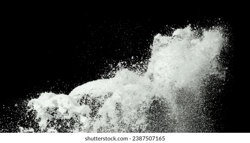 Explosion of snow falling down from sky or roof, heavy big small size snows. Freeze shot on black background isolated. Fluffy White snowflakes splash explode cloud up in mid air storm