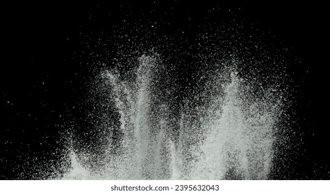 Explosion of snow falling down from sky or roof, heavy big small size snows. Freeze shot on black background isolated. Fluffy White snowflakes splash explode cloud up in mid air storm