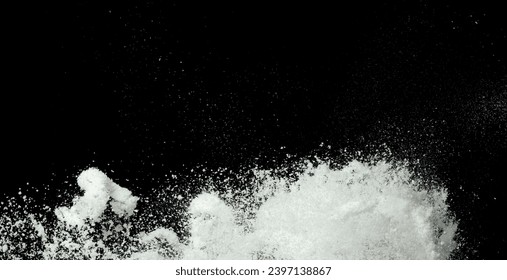 Explosion of snow falling down from sky or roof, heavy big small size snows. Freeze shot on black background isolated. Fluffy White snowflakes splash explode cloud up in mid air storm