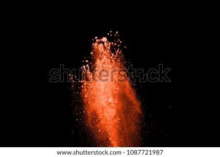 The explosion and splash of color powder. Abstract color powder explosion on black background. Abstract Freeze motion of color powder splash.