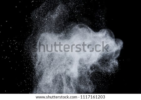 Explosion of white dust on black background. 