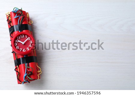 Explosive dynamite time bomb on white wooden background, top view. Space for text