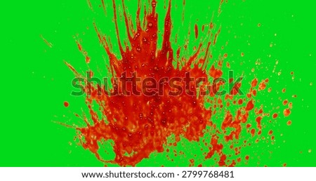 Explosive red blood splatter isolated on green screen background. Dynamic liquid impact with droplets and spray effect for chroma key compositing, VFX and video production.