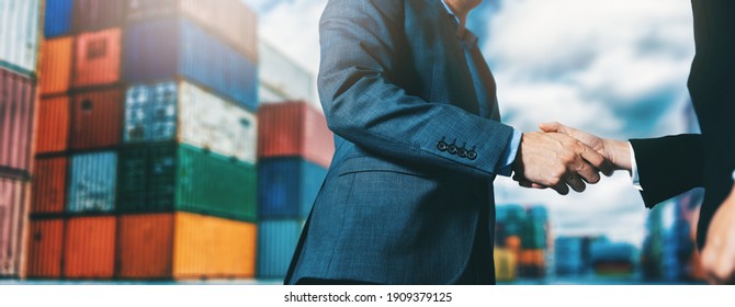 Export And Import Business. Businessmen Handshake At Industrial Container Terminal. Maritime Transport And Logistics Concept