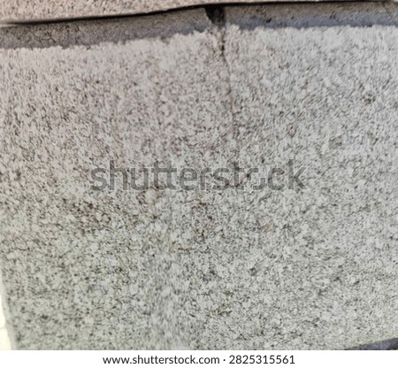Exposed aggregate concrete block texture background, rustic grey terrazzo cement panel with dark granite particles and subtle hairline crack for brutalist 3D rendering
