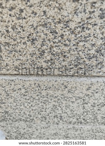 Exposed aggregate concrete blocks texture background, rustic sand-beige terrazzo cement panels with dark granite stone particles for architectural 3D rendering
