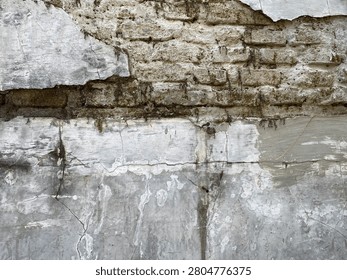 Exposed Brickwork and Flaking Stucco Wall