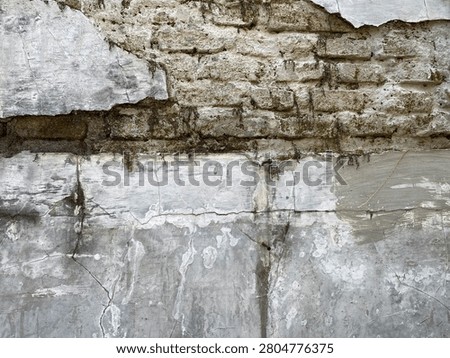 Exposed Brickwork and Flaking Stucco Wall