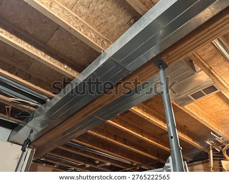 Exposed Ductwork And Pipes In Basement Ceiling