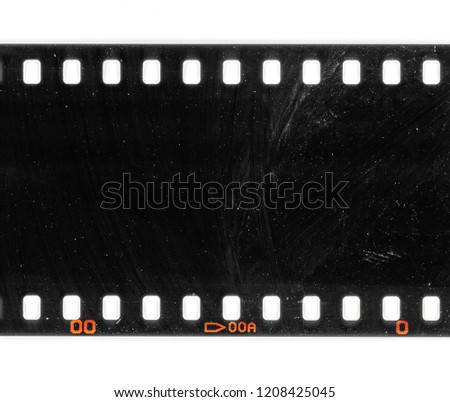 Exposed film material, long 35mm dia film strip on white, film texture with signs of usage and dust, real photo or celluloid scan