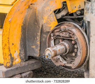 Exposed Rusty Break Shoe Assembly And Axle With Dirty White Cloth Stuffed Into Open End Of Axle.