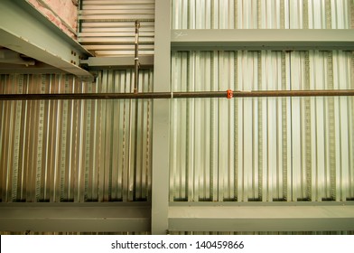 Exposed Underside Of Steel Floor Or Roof Deck With Utilities And Spray-on Fireproofing