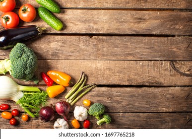 Exposition of fresh organic vegetables on wooden table. tomato, pepper, broccoli, onion, garlic, cucumber,  eggplant, black Eyed Peas