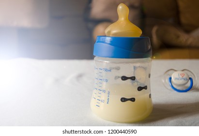 expresed milk 5 days after mother delivered baby, colostrum changing to a milk, breastfeeding concept