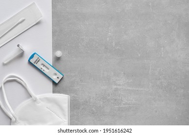 Express COVID-19 Test Schedule. Schnelltest Means Rapid Corona Test, And Selbsttest Means Self-test. Flat Lay With Antigen Covid Test Stripe, Buffer, Cotton Swab And Pp2 Medical Mask, Text Space.