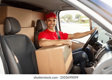 Express delivery. Happy courier guy sitting in van full loaded with parcels and boxes, looking and smiling at camera