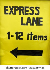 Express Lane 1-12 Items Hand Written On A Yellow Paper. Express Lane With A Arrow Pointing To The Left