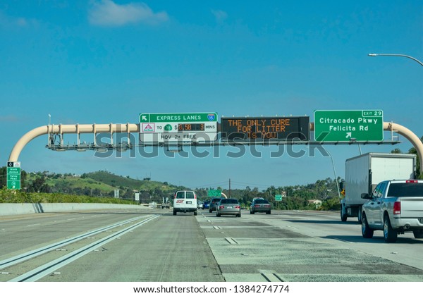 Express lanes marked by large overhead signage with\
toll amount. ‘The only cure for litter is you’ text on the\
electronic variable message sign - San Diego, California, USA -\
April 22, 2019