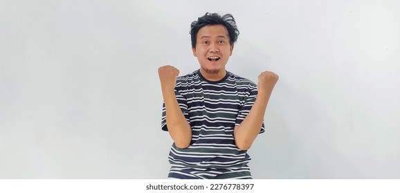 Expression Asian man happy to get something, indonesian man happy getting to something, indonesian man use the stripe shirt happy getting to something - Shutterstock ID 2276778397