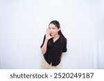 Expression of Asian woman in black dress whispering on white background