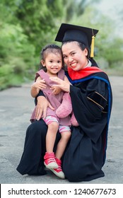 Expression of celebration with a family time, A pretty asian mom with baby girl at graduation ceremony, Emotional of a happiness and congratulation with People & Education Concept.