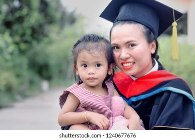 Expression of celebration with a family time, A pretty asian mom with baby girl at graduation ceremony, Emotional of a happiness and congratulation with People & Education Concept, Horizontal Image.