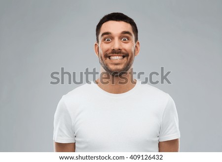 expression and people concept - man with funny face over gray background