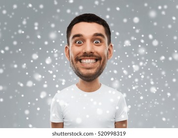 Expression, Winter, Christmas And People Concept - Smiling Man With Funny Face Over Snow On Gray Background (cartoon Style Character With Big Head)