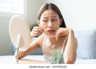 Expression Worry Asian Young Woman Hand Touching Pustule Around The Chin And Mouth, Allergic When Wear Mask, Makeup, Show Squeezing Pimple Spot From Face. Beauty Care, Skin Problem By Acne Treatment.