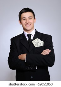 Expressions - Young Handsome Business Man In Black Suit And Tie Counting Money. Gray Background