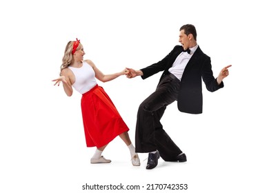 Expressive couple of dancers in vintage retro style outfits dancing social dance isolated on white background. Timeless traditions, 60s ,70s american fashion style. Dancers look excited - Shutterstock ID 2170742353